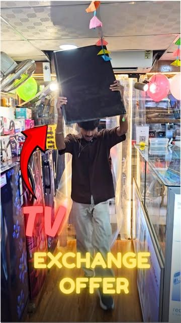 Customer carrying a new TV out of the shop